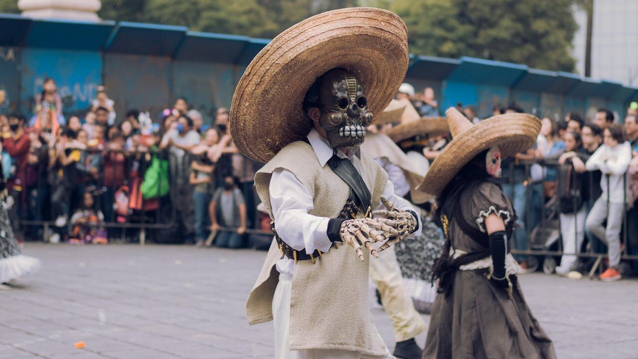 A man wears an elaborate mask during a Day of the Dead celebration. Image: Fernando Paleta / Pexels. 