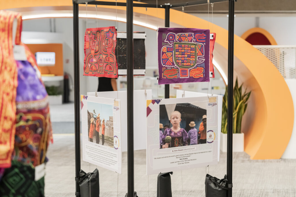 Mola textiles are displayed at the exhibition with an accompanying plaque.