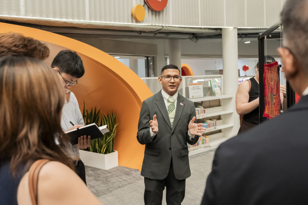 Mr Ortega gladly leads a group of attendees around the exhibition.